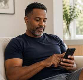 Man completing an online health questionnaire on his phone
